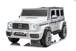 Voiture électrique pour enfants Mercedes-Benz G63 AMG 4x4, deux places, blanche, lecteur MP3 avec connexion USB/AUX et Bluetooth, transmission 4x4, batterie lithium, roues EVA avec suspension, sièges en similicuir, télécommande, modèle sous licence
